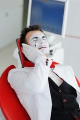 A man in a dental chair suffers from a toothache
