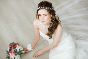 Brunette bride in fashion white wedding dress with makeup