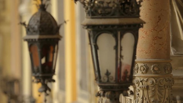 Beautiful vintage lamps hanging on medieval building, ancient architecture