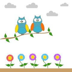 Owls on a branch of a tree