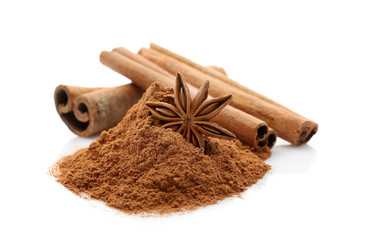 Cinnamon sticks and powder with anise star isolated on white, closeup