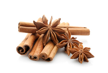 Cinnamon sticks with anise stars isolated on white, closeup