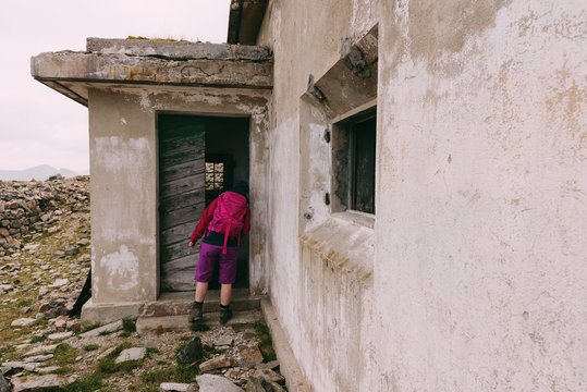 Wanderer schaut in einen verfallenen Bunker am Grenzkamm zwischen &Ouml;sterreich und Italien