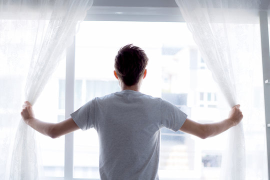 Man And Hope Concept - Man Opening Window Curtains Business Concept.