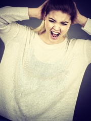 Unhappy woman screaming and yelling in pain
