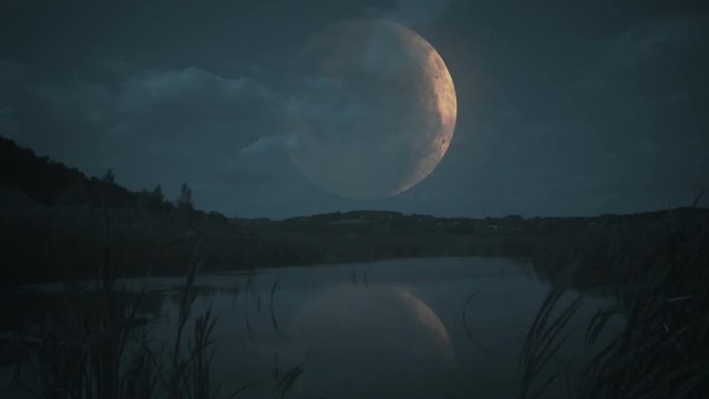 Giant moon over the lake or sea.