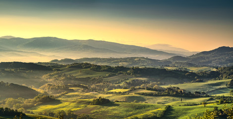 Naklejka na ściany i meble Tuscany Maremma foggy morning, farmlands and green fields. Italy.