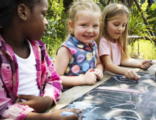 Group of kindergarten kids friends drawing art class outdoors