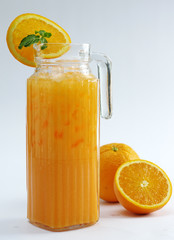 Glass of orange wine with fresh fruit on white background