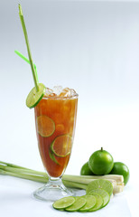 Glass of fresh lime tea with lemongrass on white background