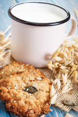 Fresh baked oatmeal cookies, ingredients for baking and ears of oat, healthy dessert concept