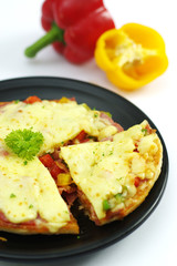 Pork pizza with bell chili on black platter