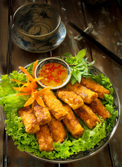 Vietnamese crispy spring rolls or Nem nuong with fish sauce and lettuce