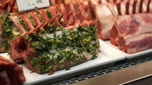 Raw rack of lamb sell in market. Raw meat and herb marinated at butcher shop
