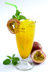 Glass of fresh passion fruit tea with mint leaf on white background