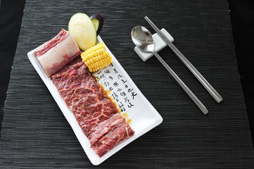 Fresh beef with cucumber and corn on white platter
