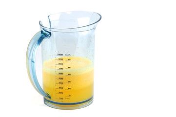 fresh made orange juice in measure cup