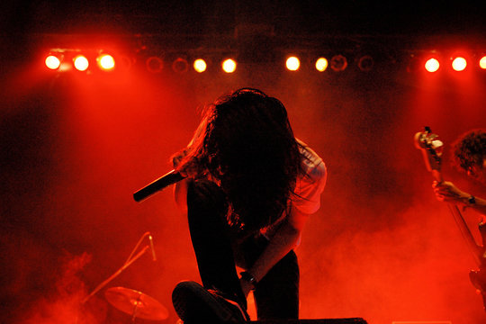 Metal vocalist silhouette on red stage light