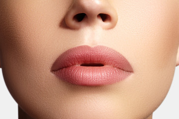 Closeup perfect natural lip makeup. Beautiful plump full lips on female face. Clean skin, fresh...