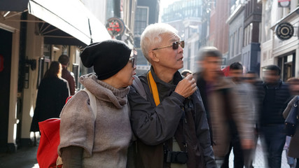 Asian senior couple lost in Europe. Travel after retirement and get confuse during the trip