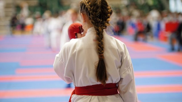 Young karateka preparing for sparing with the competitor