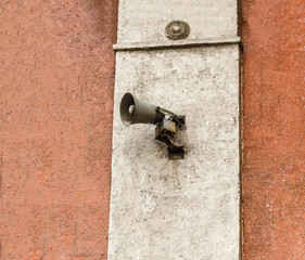 Loudspeaker on plastered beige wall