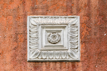 Square stucco decoration on red wall