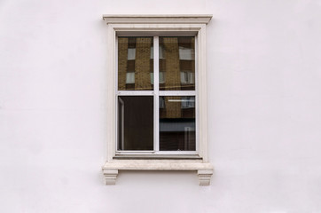 Beautiful window on white plaster wall