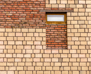 Fototapeta na wymiar Small window on brick wall