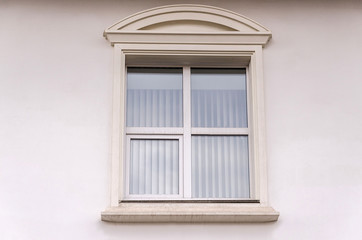 Beautiful window on white plaster wall