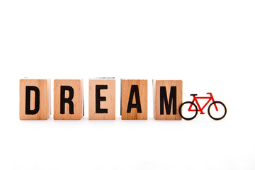 Dream Bike - wooden block letters and bike icon on white background
