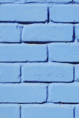 Brick wall painted blue paint close-up. Background.