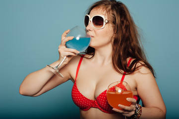 sensual woman with sunglasses drinking a cocktail