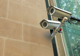 security cameras mounted on a building with intentional blur