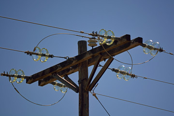 Wooden Power Pole with Antique Glass Insulators on a Sunny Day