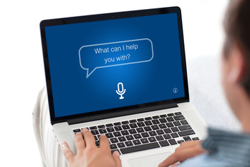 man typing laptop keyboard with app personal assistant on screen