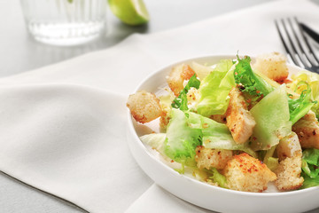 Plate with chicken salad on table