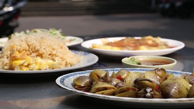 Several dishes with food in an open air restaurant at the Ci Sheng Temple in Taipei, Taiwan. Tzu Sheng Temple is a small temple in Tataocheng, one of Taipei's oldest neighborhoods.