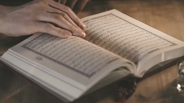 Muslim Woman Reading The Koran In Mosque