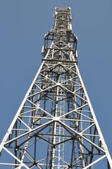 Telecommunication towers with antennas on clear blue sky
