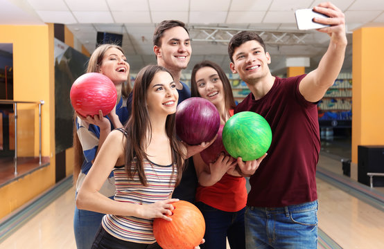 Friends taking selfie at bowling club