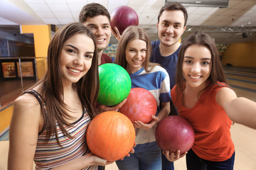 Fototapeta na wymiar Friends taking selfie at bowling club