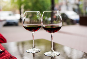 Two glasses with red wine in a cafe