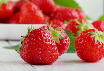 strawberries close up on white wooden background
