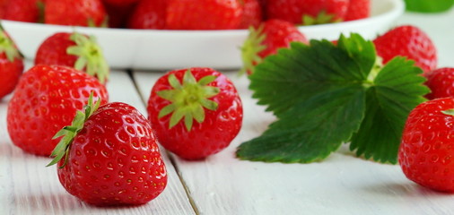 strawberries close up on white wooden background.banner