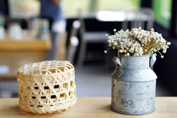 Weaving Basket and Vase of Eriocaulon henryanum ruhle flower on blurred background.