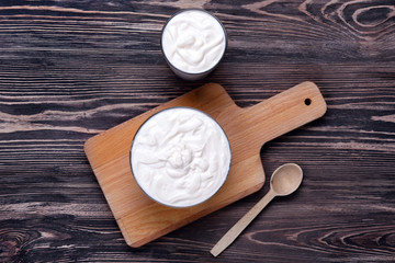 Composition with yogurt on wooden background