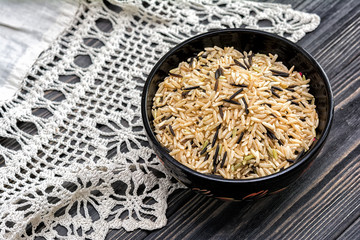 Unpolished rice on wooden background