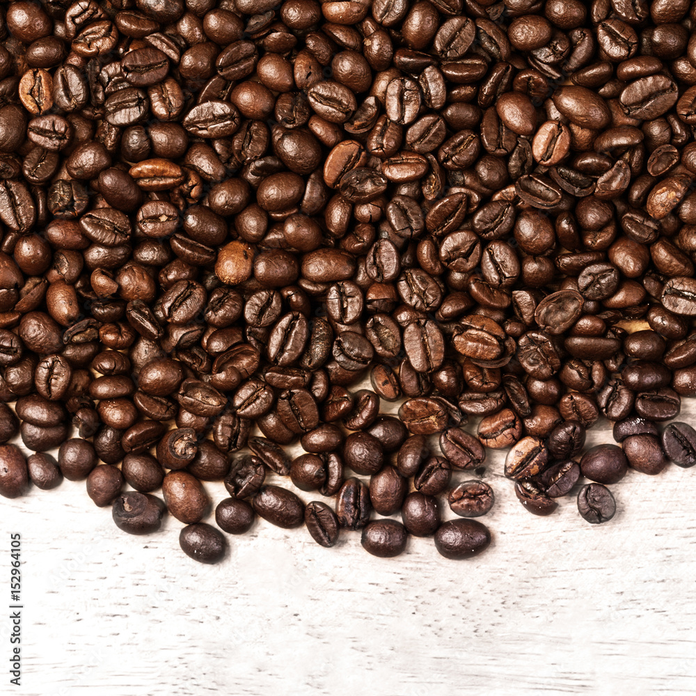 Wall mural Coffee beans background macro. Dark Roasted coffee beans textured wallpaper for your design with copy space.