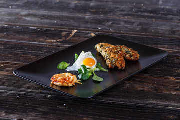 Schnitzel with fried egg sunny side up and pizza